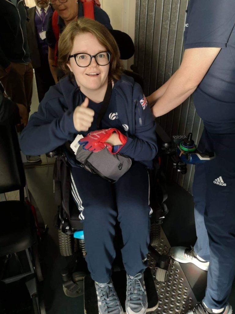 Special Assistance lifting disabled passenger to aisle chair